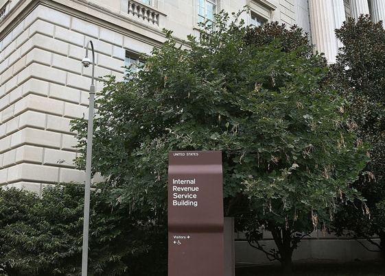 Internal Revenue Service sign in front of a tree
