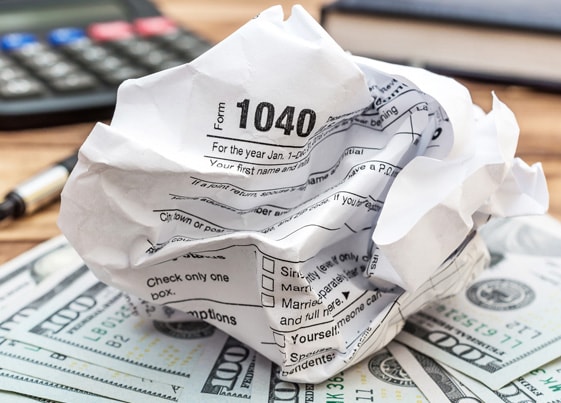crumpled up 1040 IRS tax form